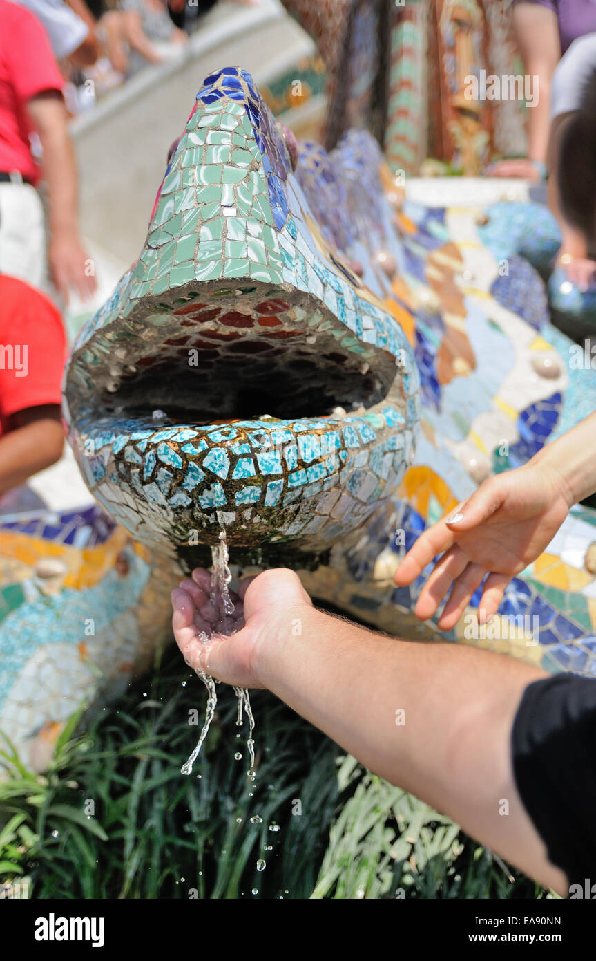 BARCELONA - JULY 12: People watch The dragon designed by Gaudi at the Park Guell on July 12, 2013 in Barcelona, Spain. Stock Photo