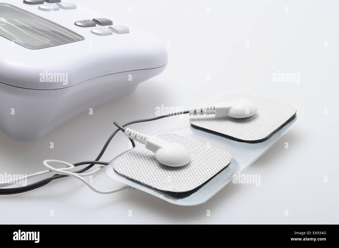 Close up of white electrodes and electrical stimulation device Stock