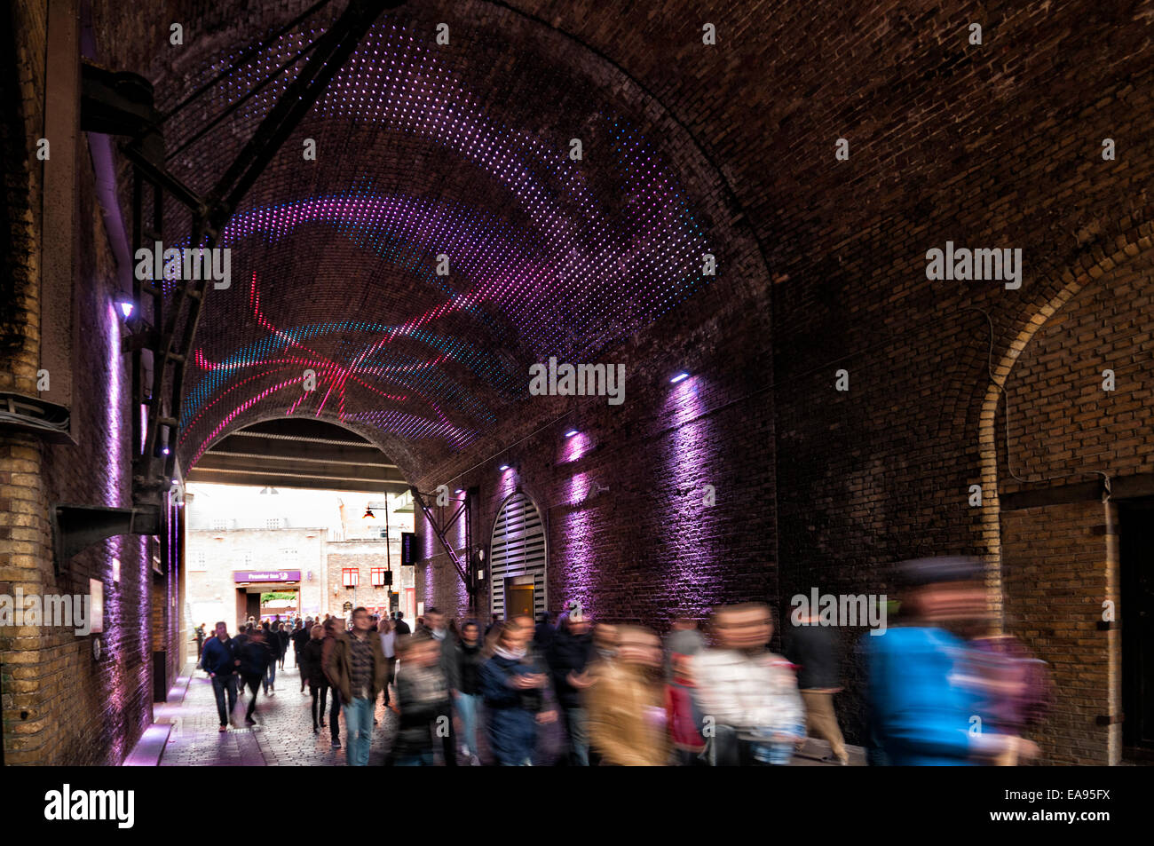 Railway arch on London's Southbank with laser light display projected onto the ceiling Stock Photo