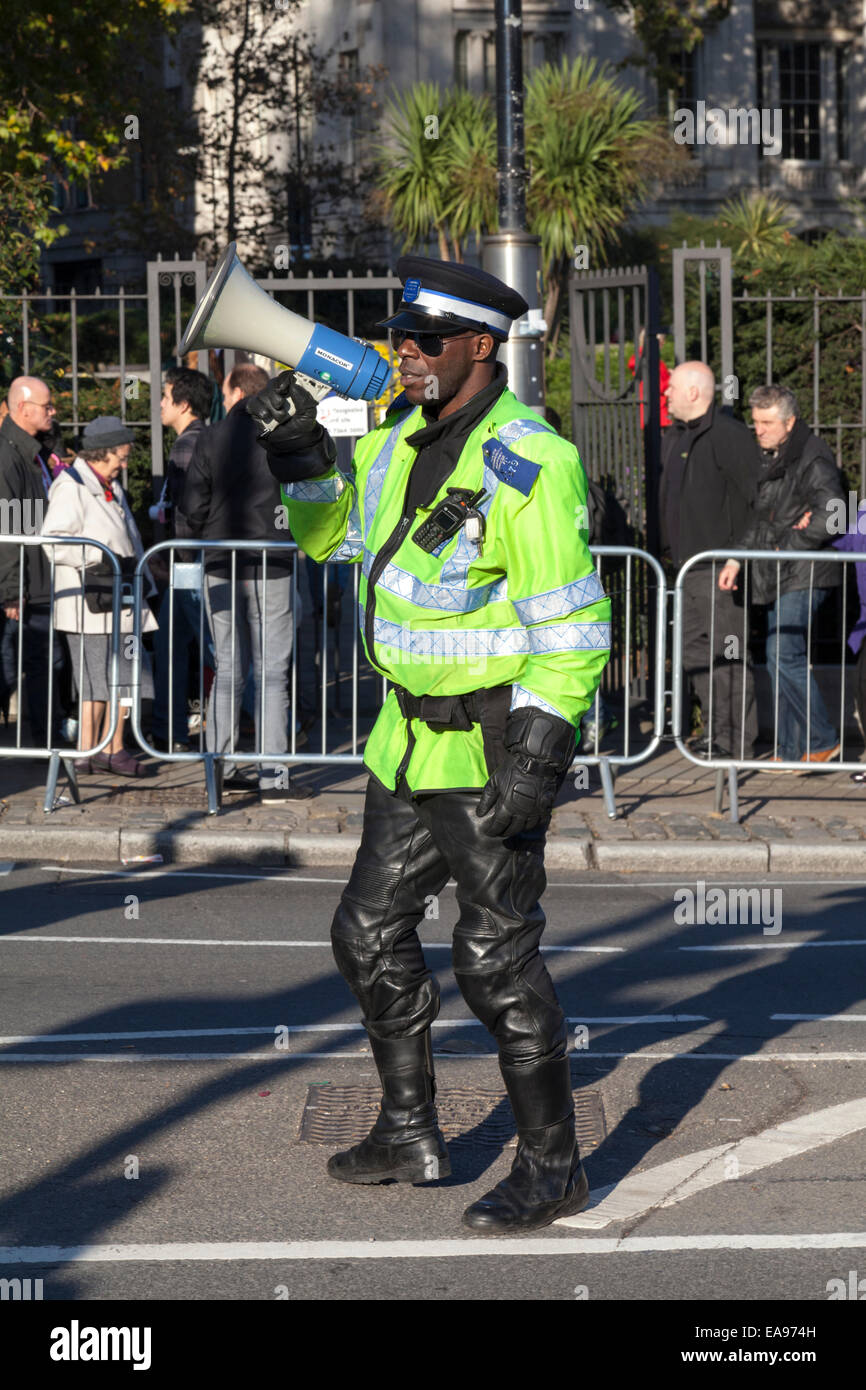 London Community Support Officer takes crowd control measures to ease congestion around Tower Hill Underground Station. Stock Photo