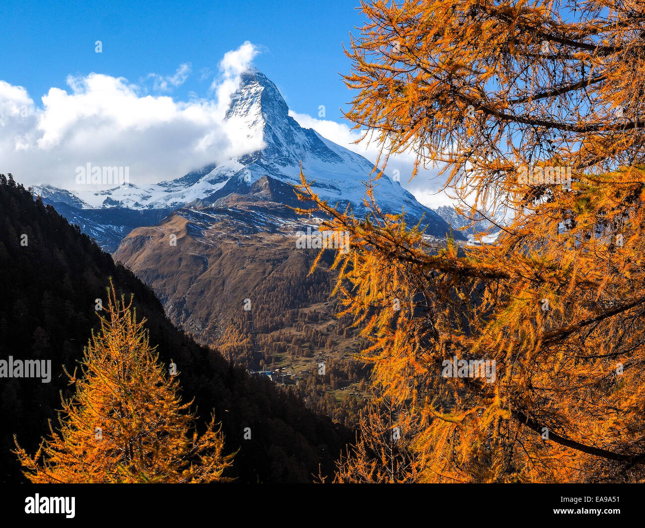 Autumn view on snowy Mountains with some water on foreground, Wallis, Switzerland Stock Photo