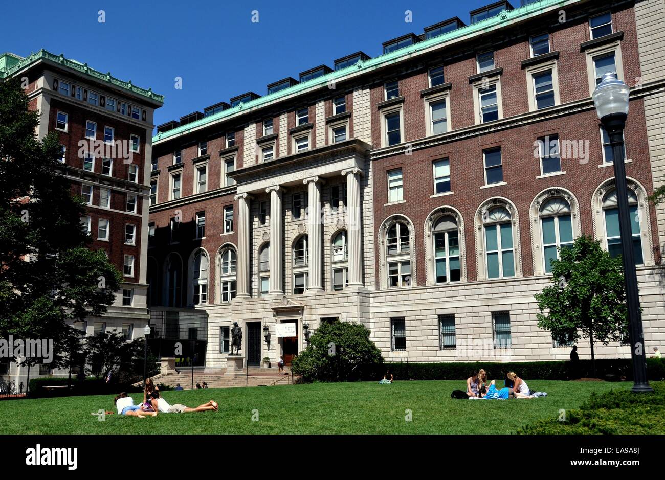 New York City:  Students lounge on the lawn in front of the Columbia University School of Journalism building Stock Photo