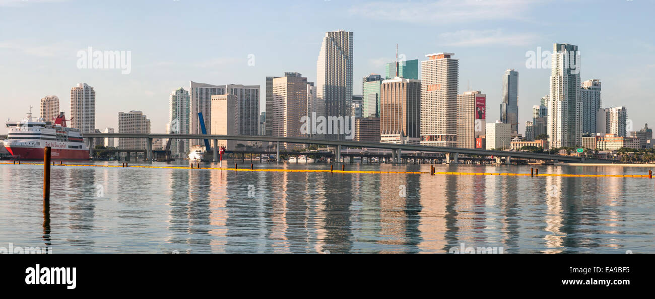 High-rises of the Miami skyline are reflected in the calm waters of ...