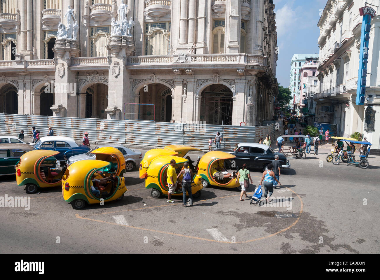 Distinctive Coco taxis wait for tourist business while parked on Paseo del Prado in central Havana Cuba Stock Photo