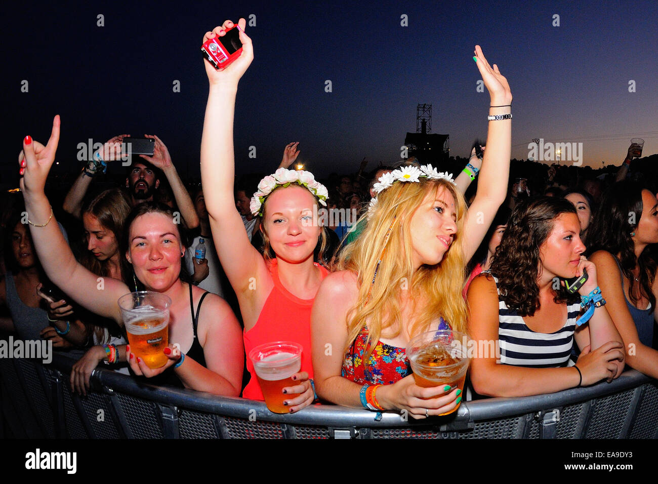 BENICASSIM, SPAIN - JULY 18: Women from the audience dancing at FIB Festival on July 18, 2014 in Benicassim, Spain. Stock Photo