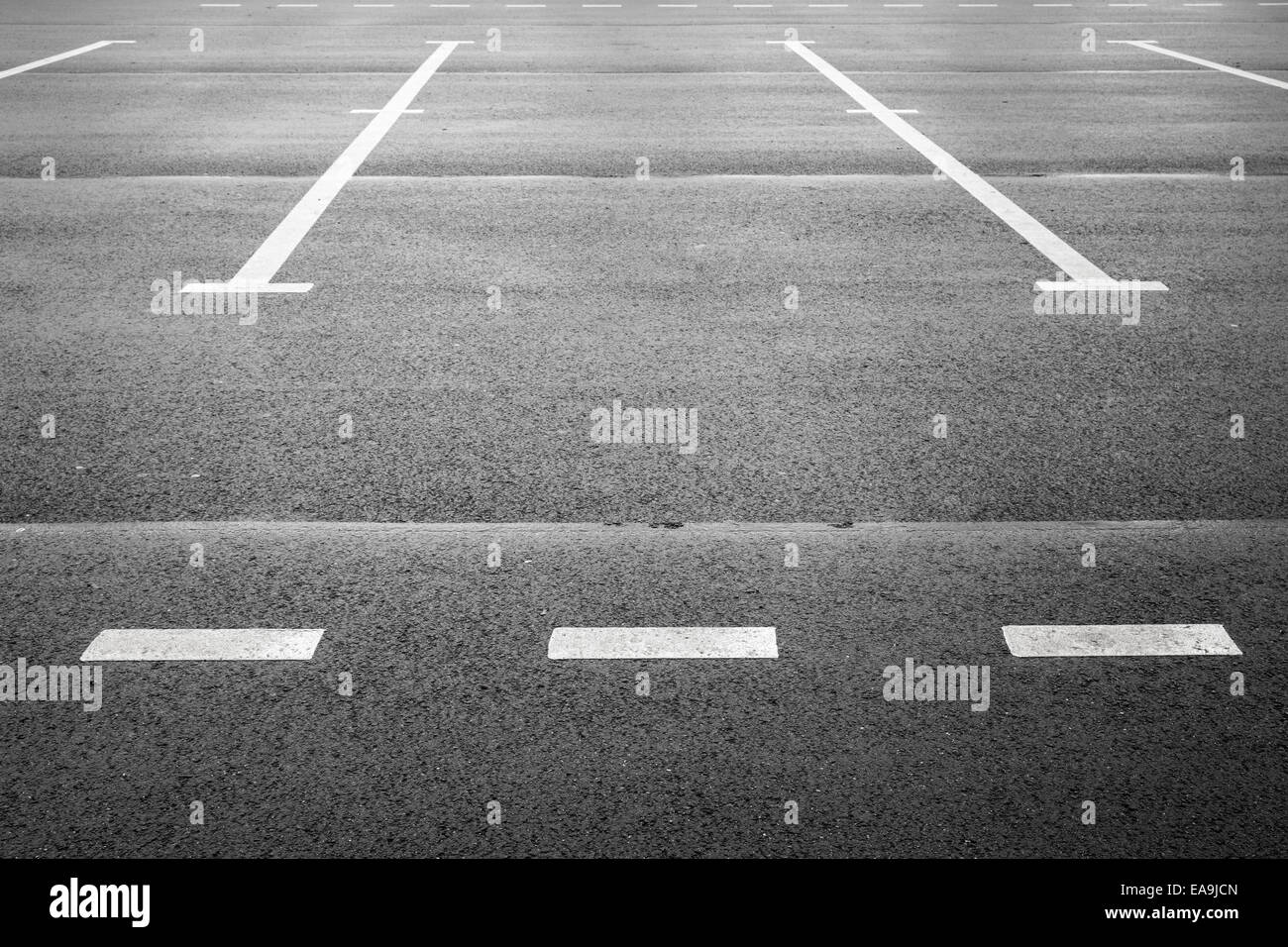 Vacant parking place, an empty space on asphalt pavement with white road marking Stock Photo