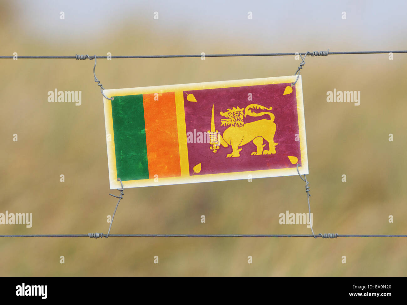 Border fence Old plastic sign with a flag Sri Lanka Stock Photo Alamy