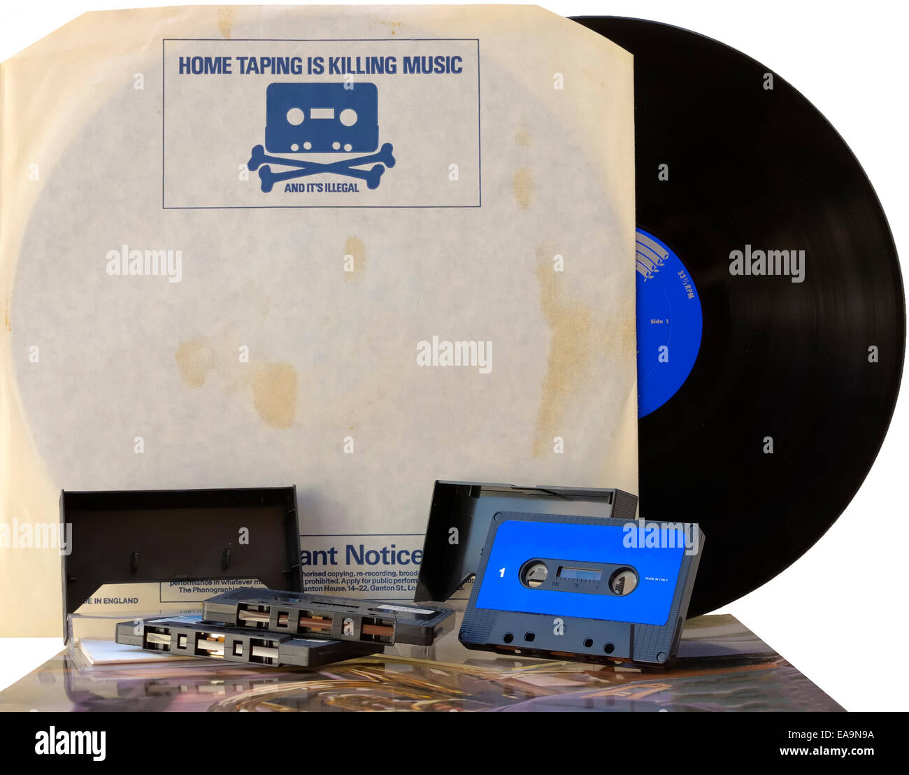 Retro graphics vinyl record inner sleeve with 1980s anti copyright infringement campaign skull and crossbones with cassette tape Stock Photo