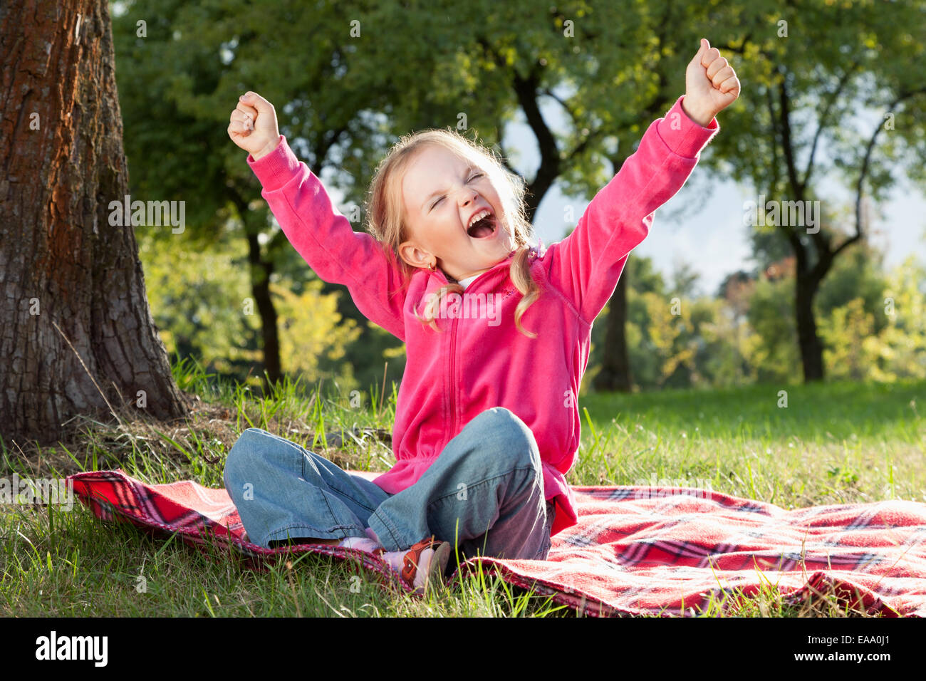 happy little girl with hands up in summer park Stock Photo - Alamy
