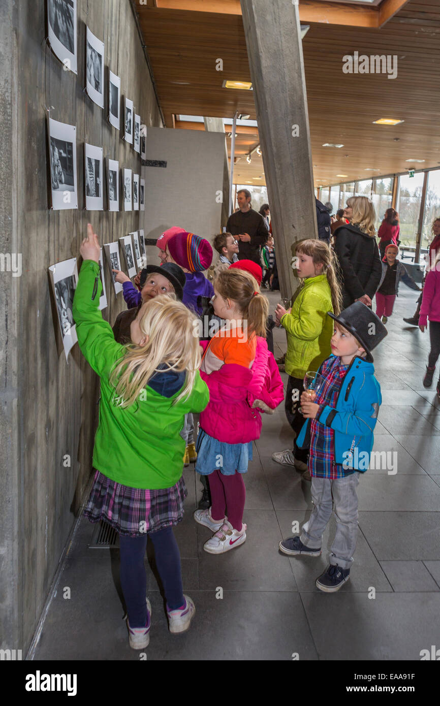 Children at a photo exhibition, looking at pictures of themselves. Reykjavik, Iceland Stock Photo