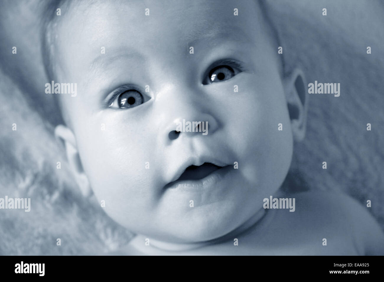 Little Baby Girl closeup of face in blue Stock Photo