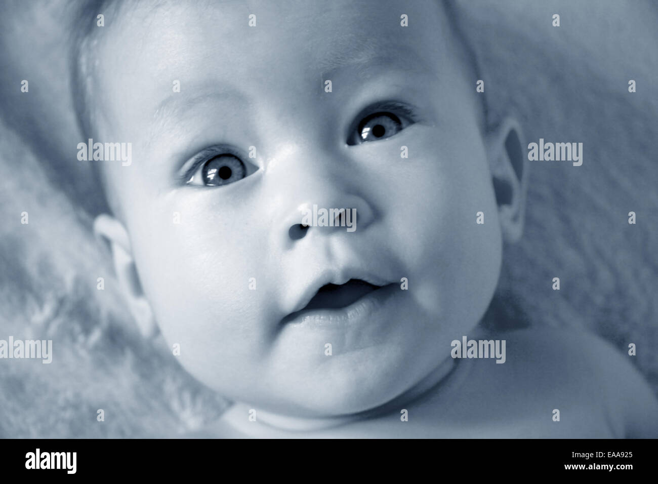 Little Baby Girl closeup of face in blue Stock Photo - Alamy
