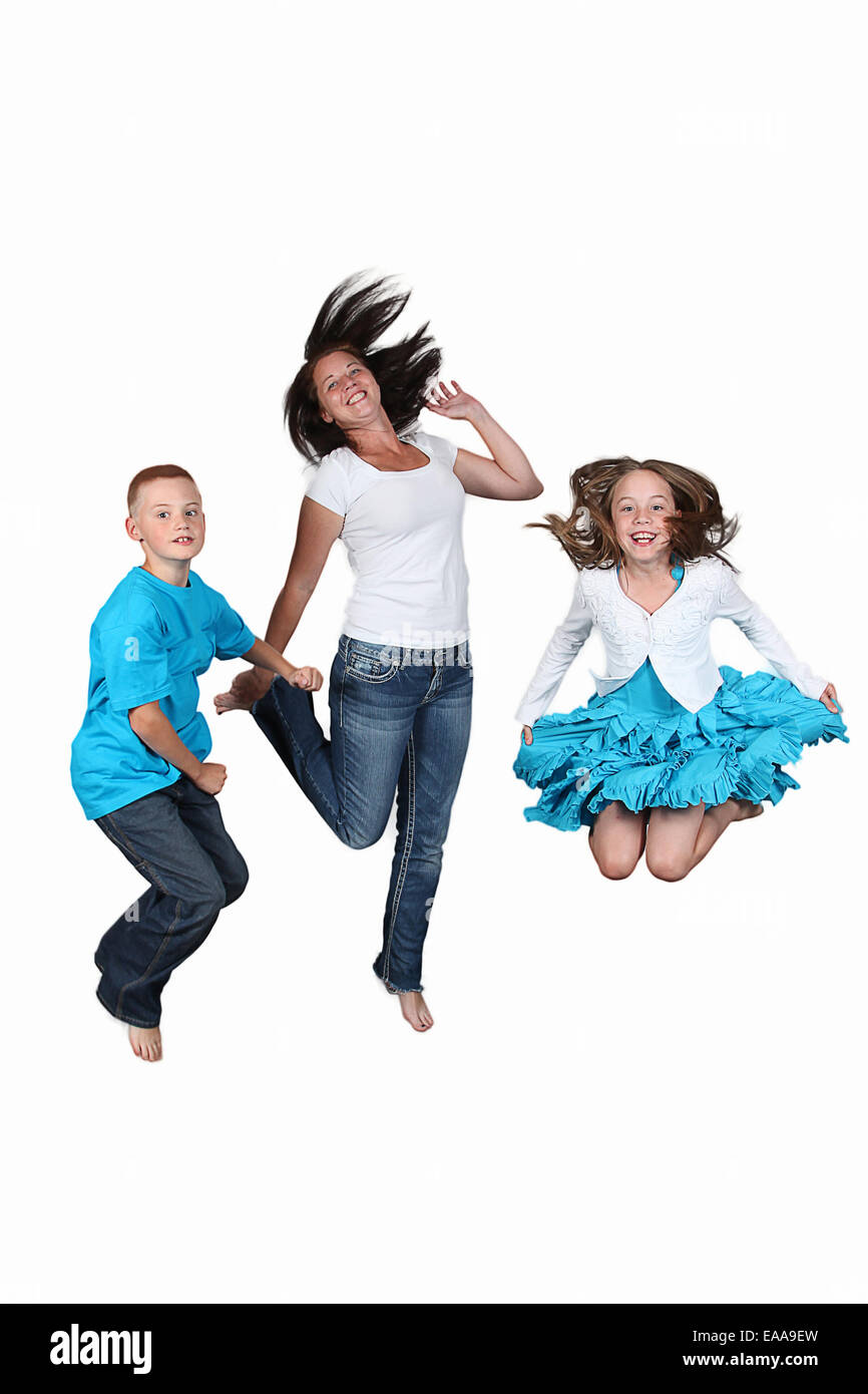 Mother and two kids jumping in the air together Stock Photo