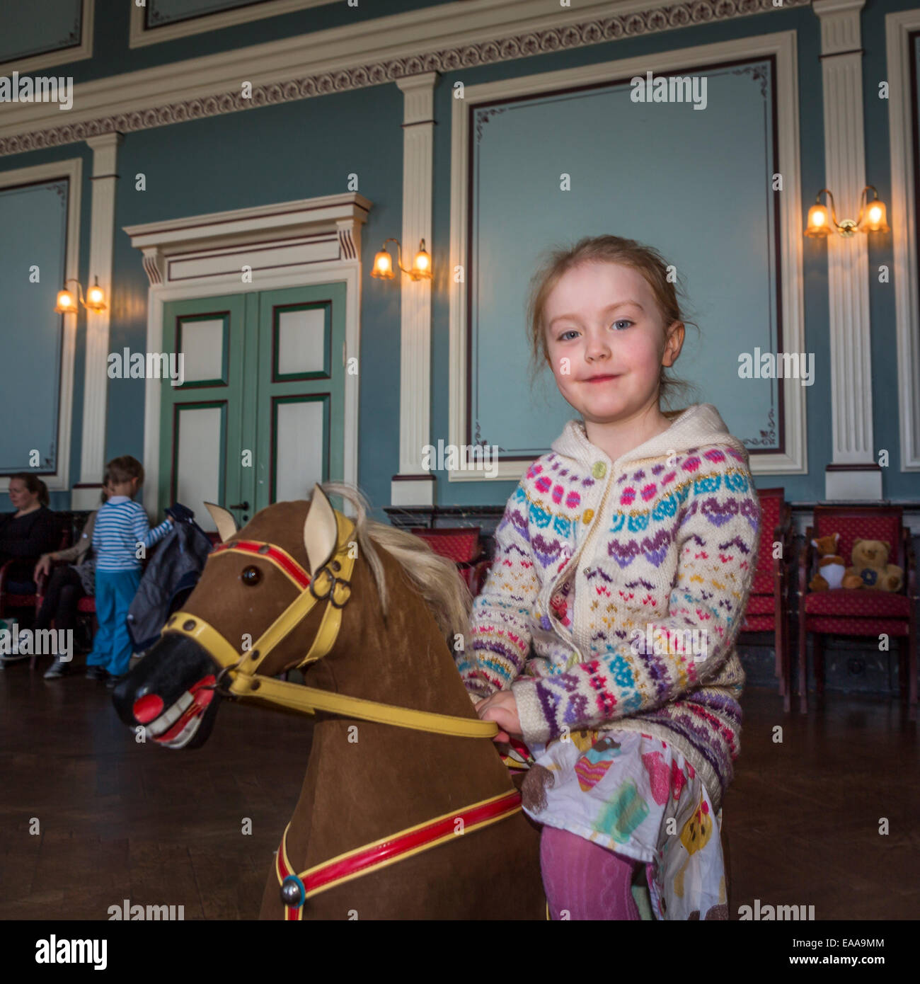 Portrait of Girl on a toy horse, Reykjavik, Iceland Stock Photo