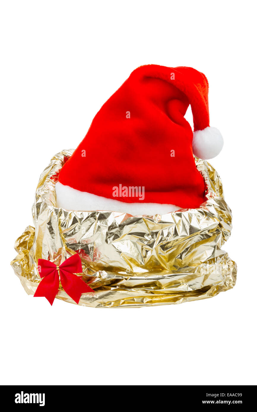 Santa Claus red hat in gift wrapping paper of gold color Stock Photo