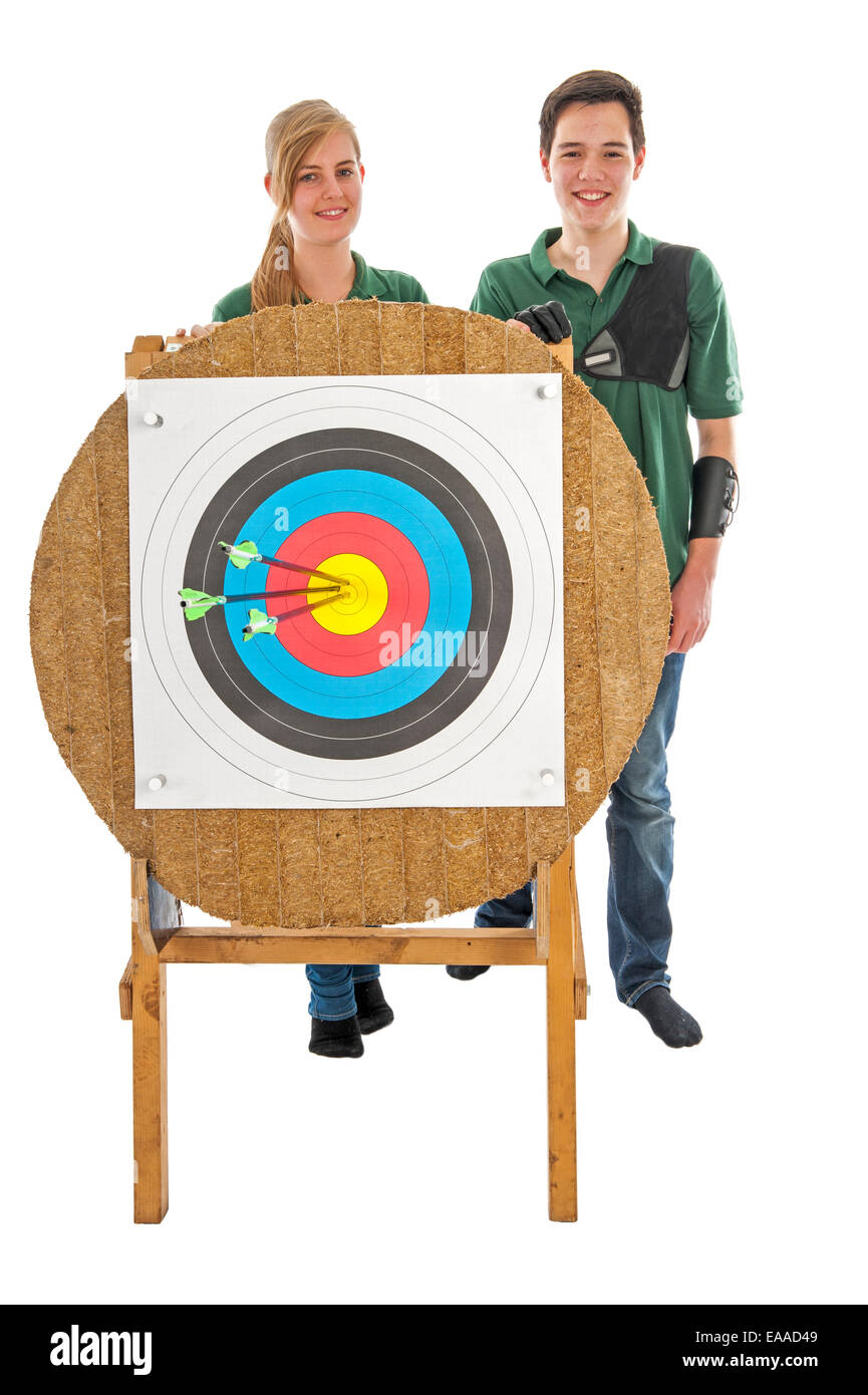 Young girl and boy standing behind the bull's eye of an archery target Stock Photo