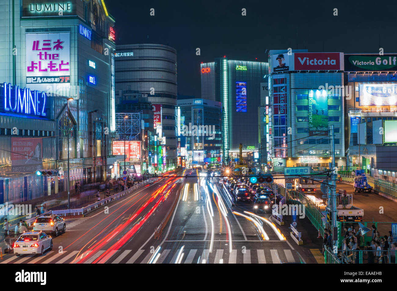 Shinjuku with traffic on Yasukuni Dori Street, and Kabukicho entertainment district at night, Tokyo - Japan Stock Photo