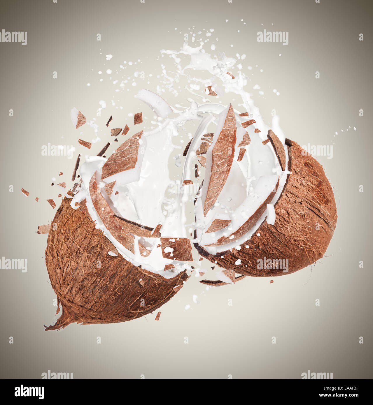 Coconut in motion with breaking pieces Stock Photo