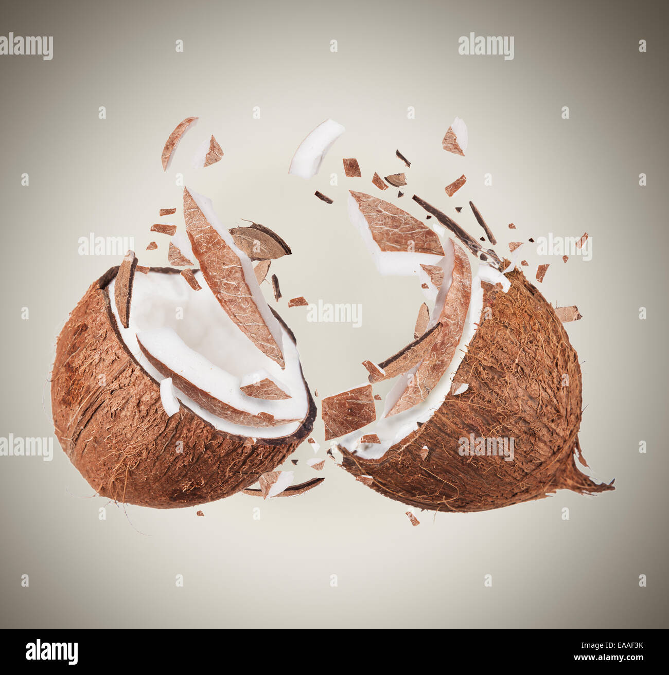 Coconut in motion with breaking pieces Stock Photo