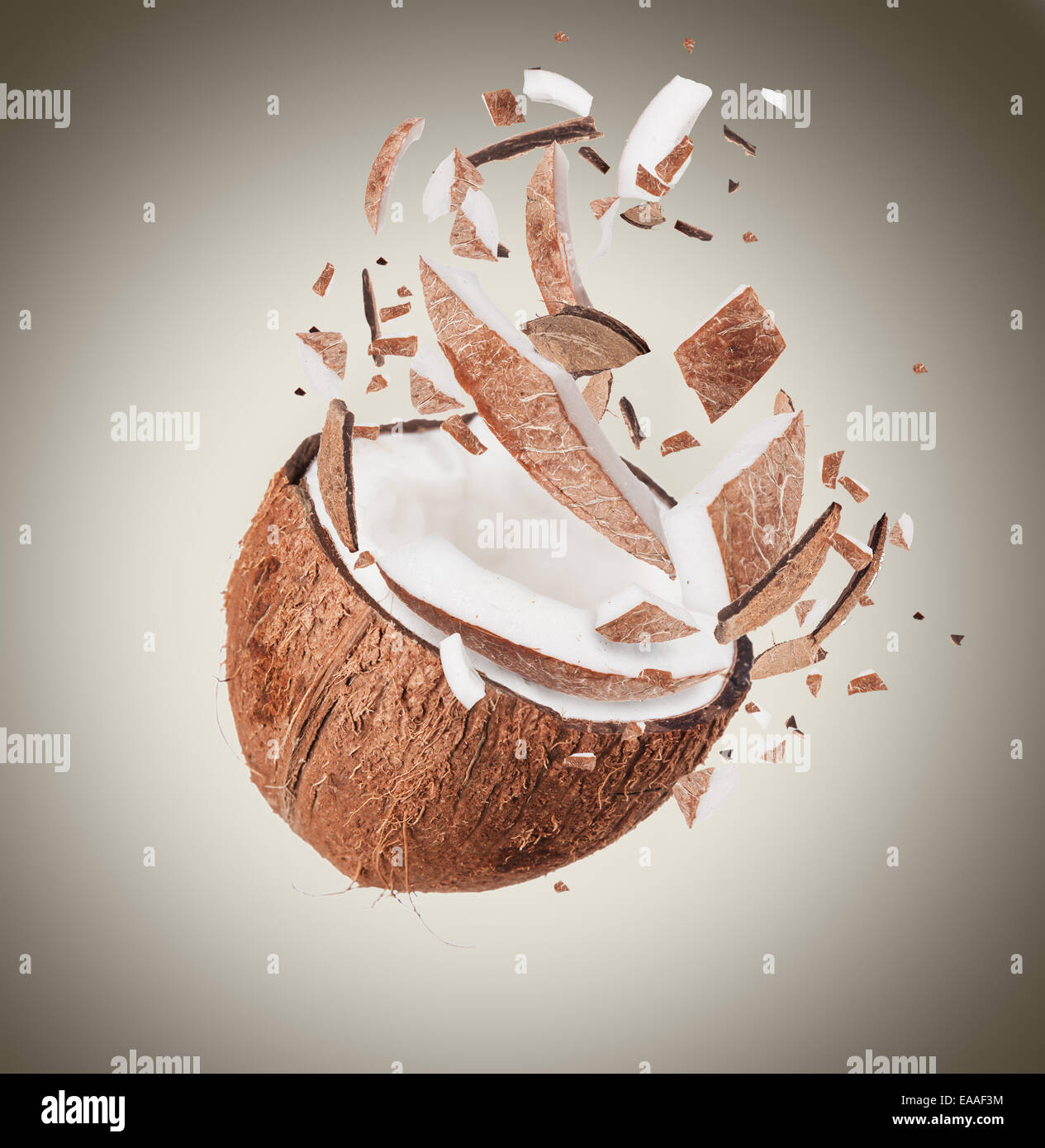 Coconut in motion with breaking pieces Stock Photo