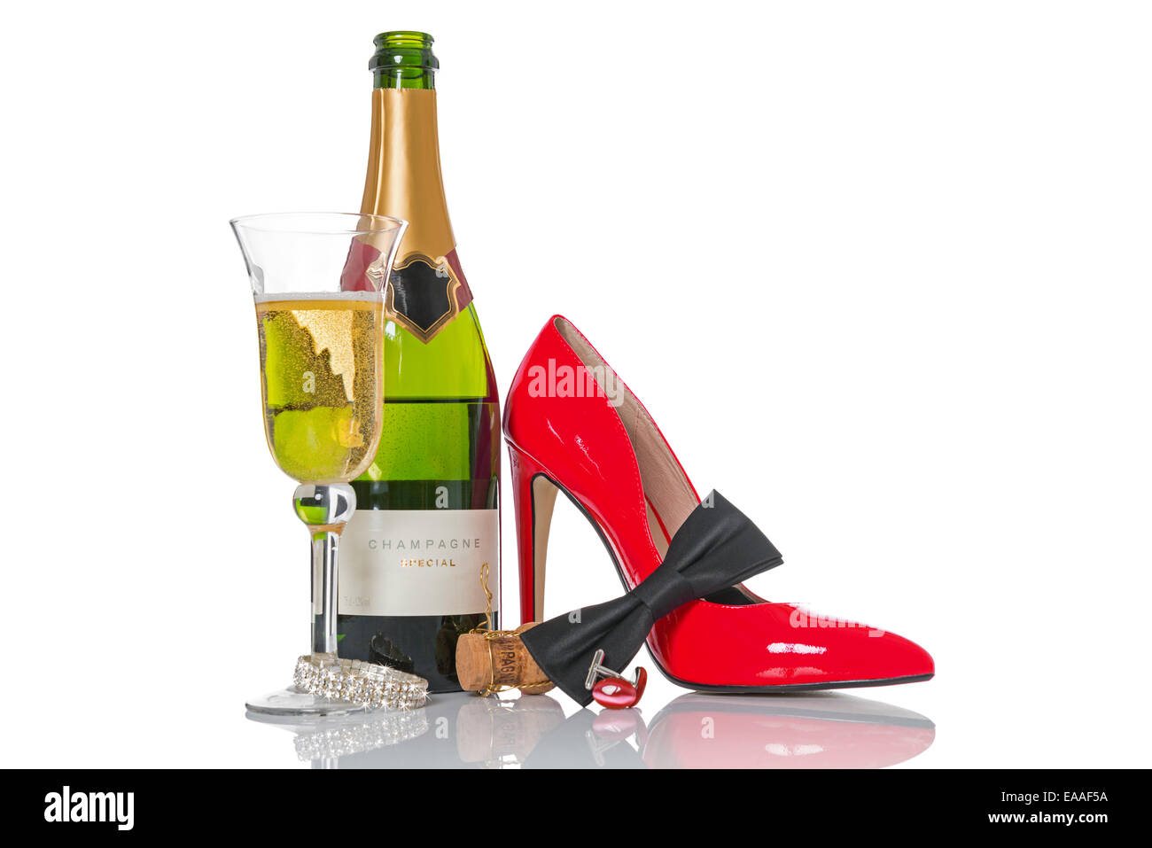 Champagne and black tie with red shoes and accessories isolated on a white background. Stock Photo