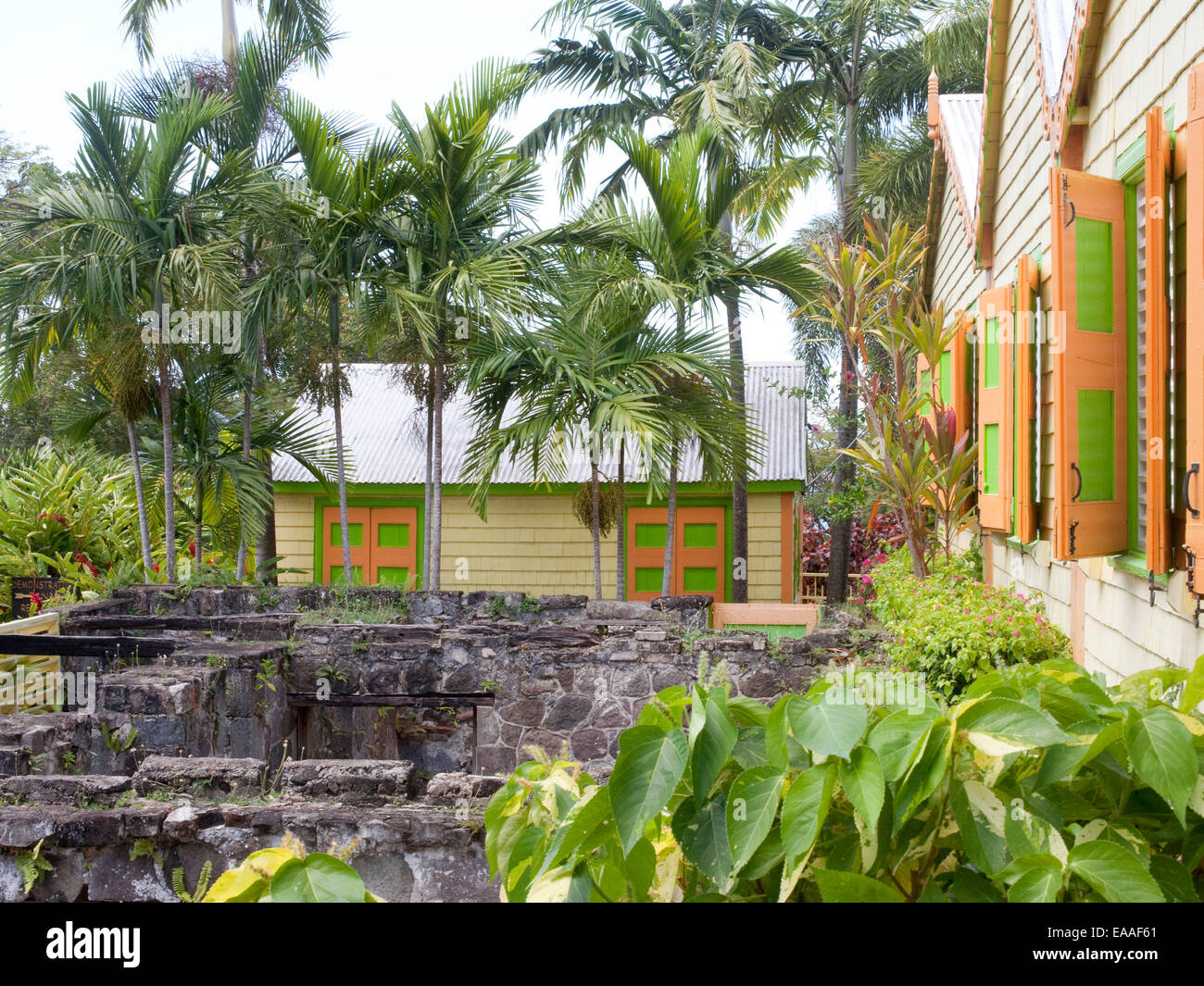 brightly colored small wooden house and old foundation. Stock Photo