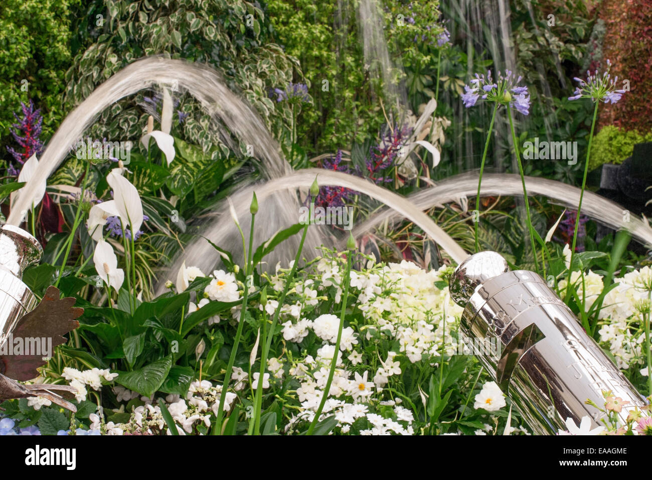 Chelsea Flower Show 2014. Water cannons part of an indoor plant display Stock Photo