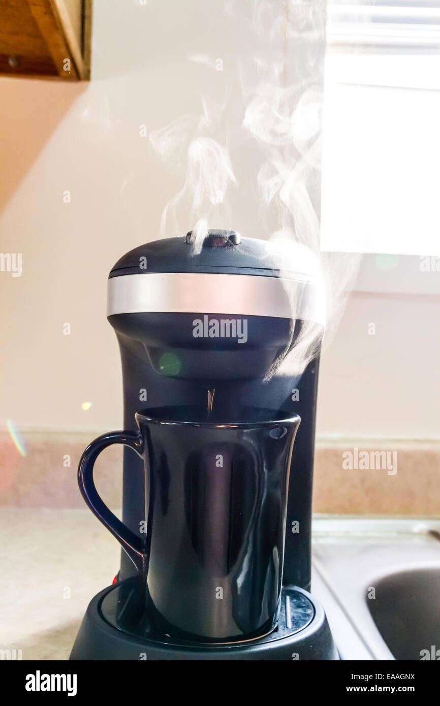 Steam rising from a single cup coffee maker Stock Photo Alamy