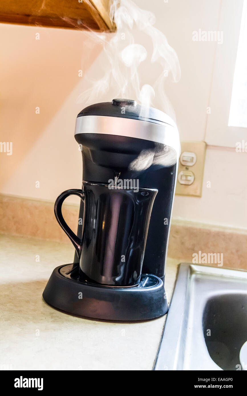 Steam rising from a single cup coffee maker Stock Photo Alamy