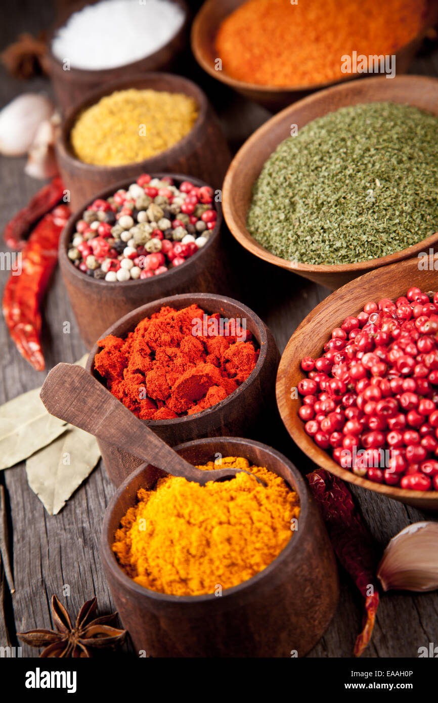 Various kind of spices in wooden bowls Stock Photo