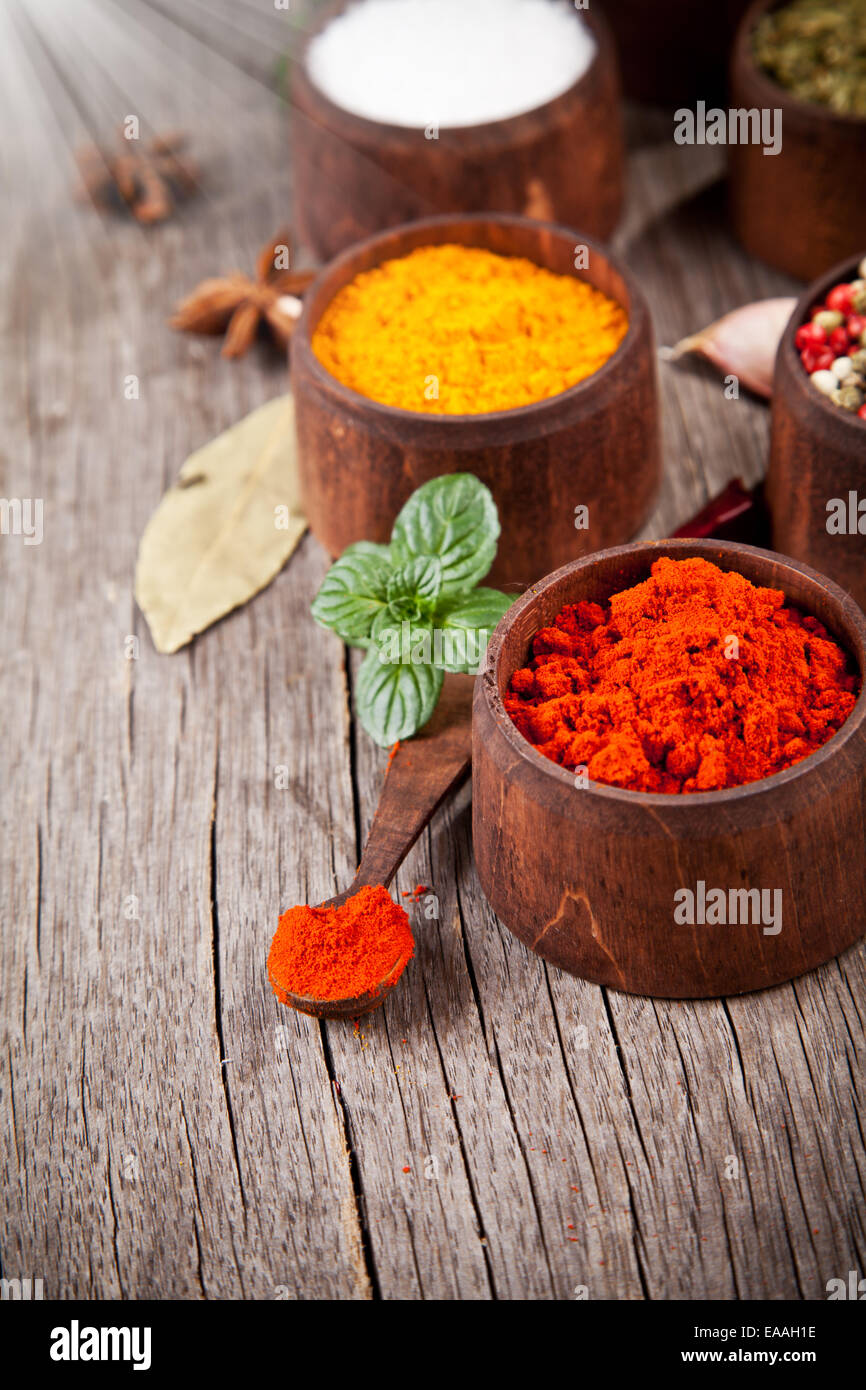 Various kind of spices in wooden bowls Stock Photo