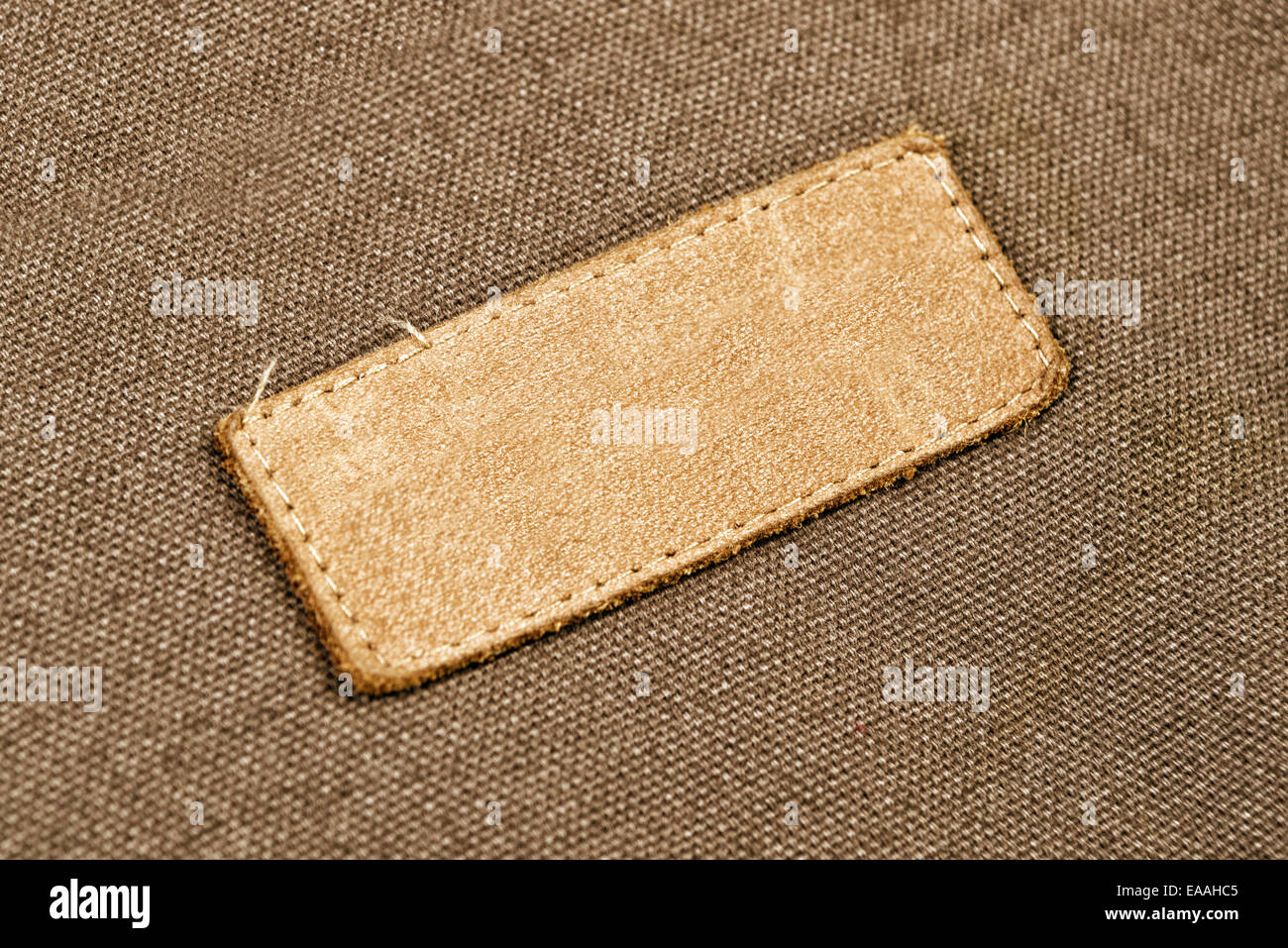 Blank Leather Label Tag on cotton fabric material texture background ...