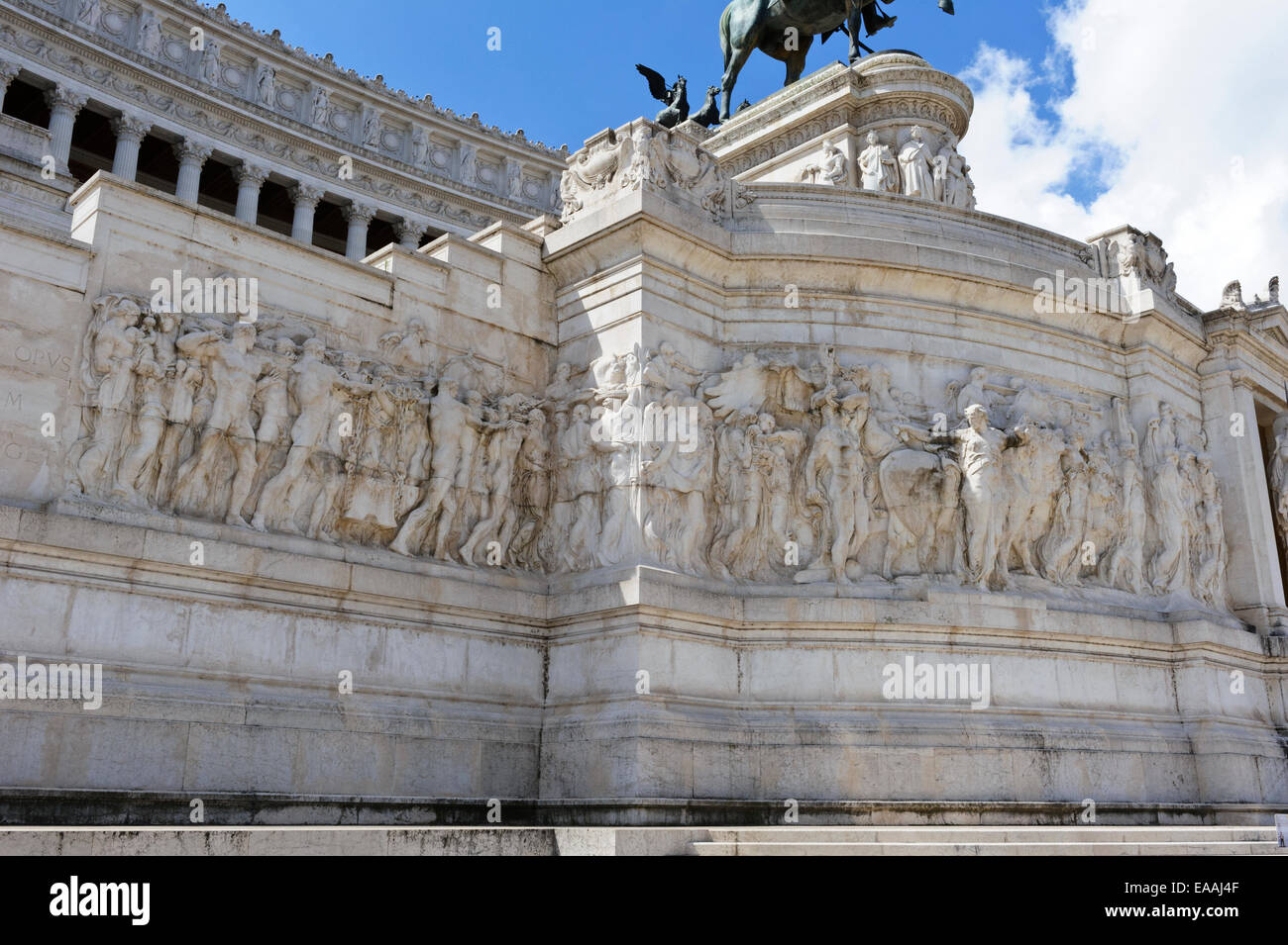 Stone carvings of ancient Roman figures on the white marble exterior