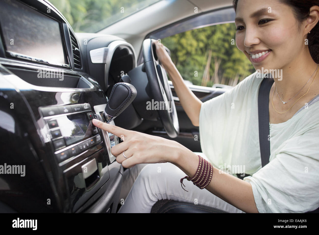 A young woman sitting in her car. Stock Photo