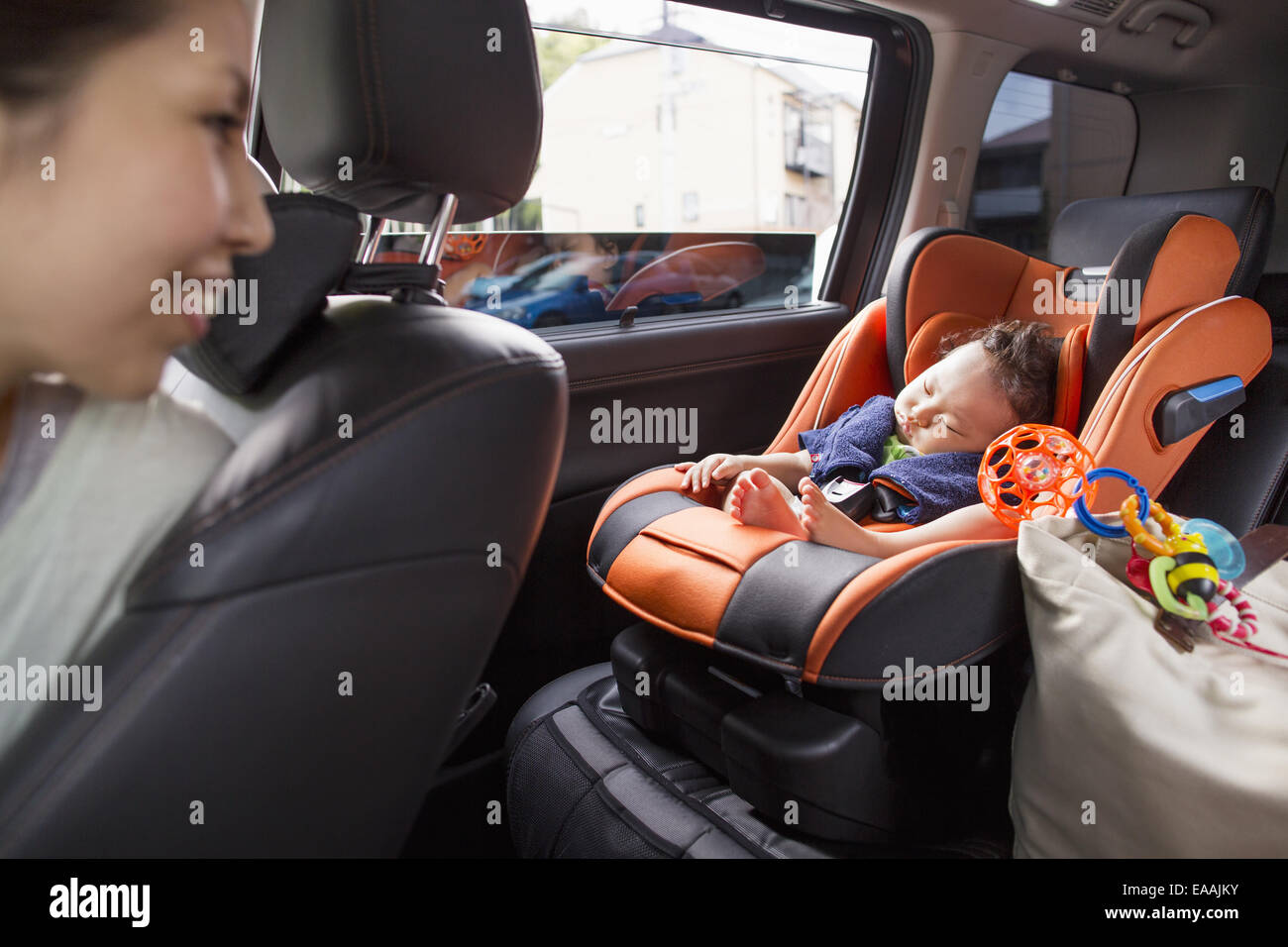 A mother and her young baby boy in a car. Stock Photo