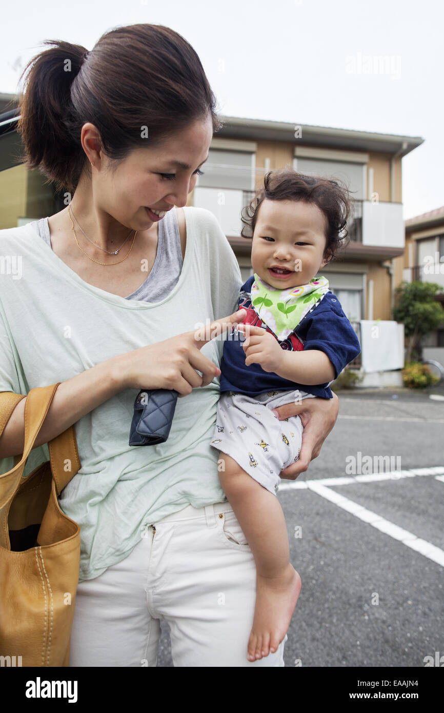 Woman carrying baby full length hi-res stock photography and
