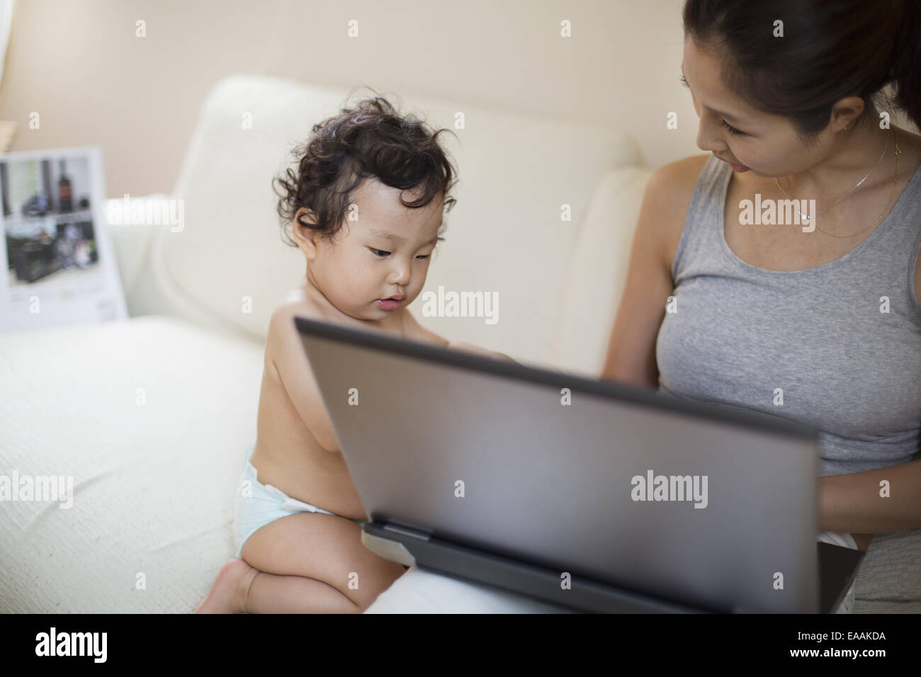 A mother with her baby boy at home. Childcare. Stock Photo