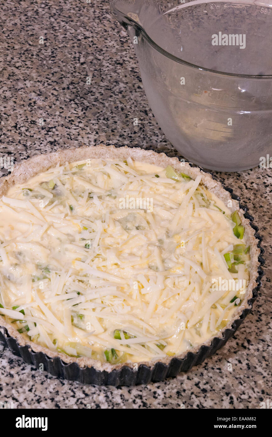 Making a leek and cheese flan from leeks grown organically in the garden sequence. Step 8 Ready for the oven Stock Photo