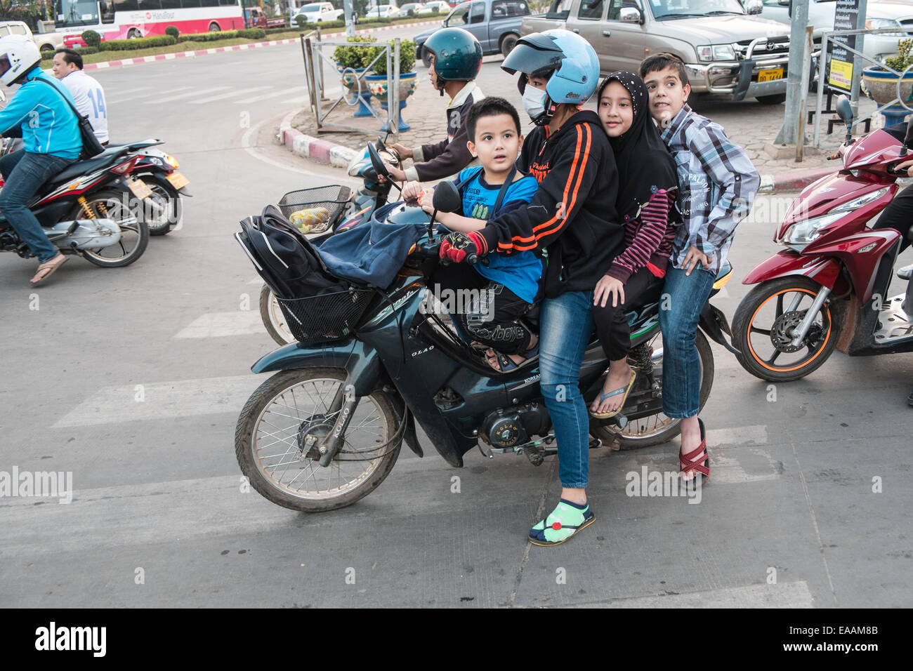 Family of four,4, on a motorbike in centre of Vientiane,capital of, Laos,  South East Asia, Asia Stock Photo - Alamy