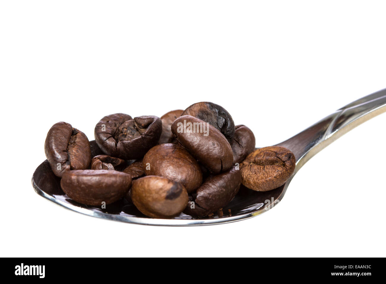 Coffee beans on a spoon isolated over white background Stock Photo - Alamy