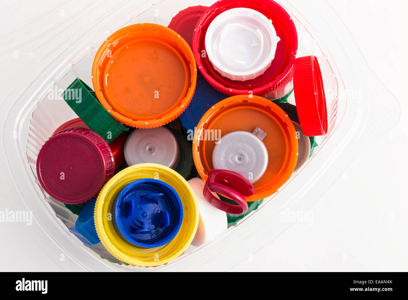 lots of plastic plugs in a plastic container isolated on white
