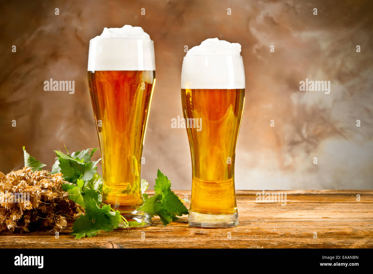 Beer keg with glasses of beer and blur background Stock Photo - Alamy