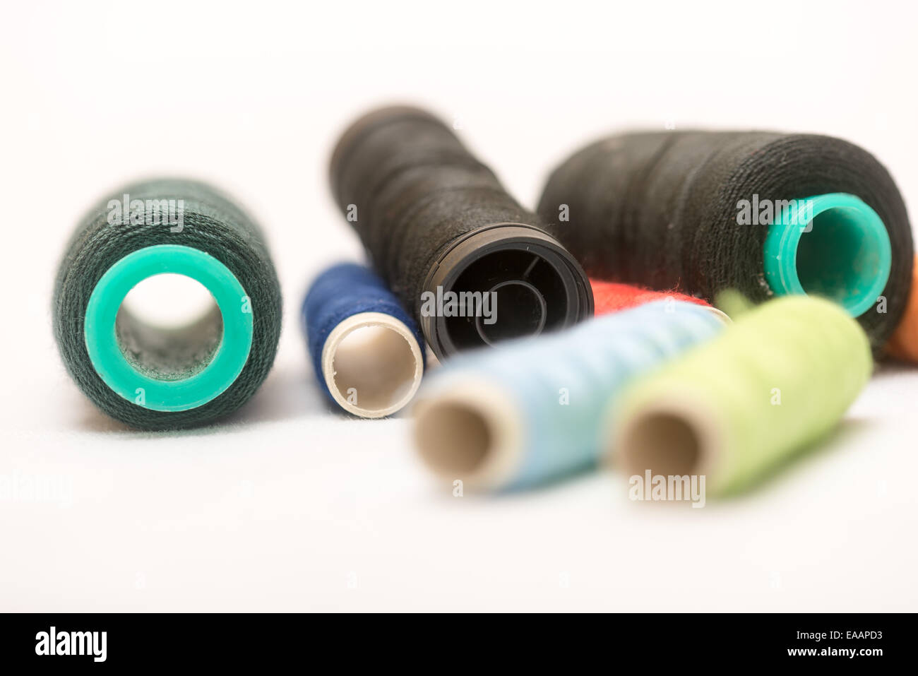 set of colorful spools of thread on a white background Stock Photo - Alamy