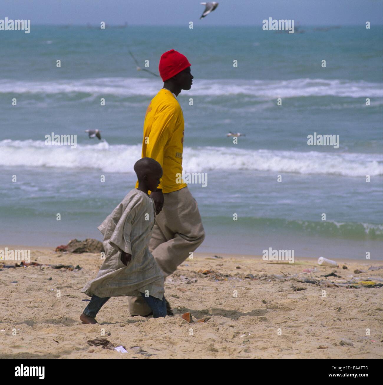 Father walking on beach with his son, Beach of Langue de Barbari, Saint Louis , Senegal, West Africa Stock Photo