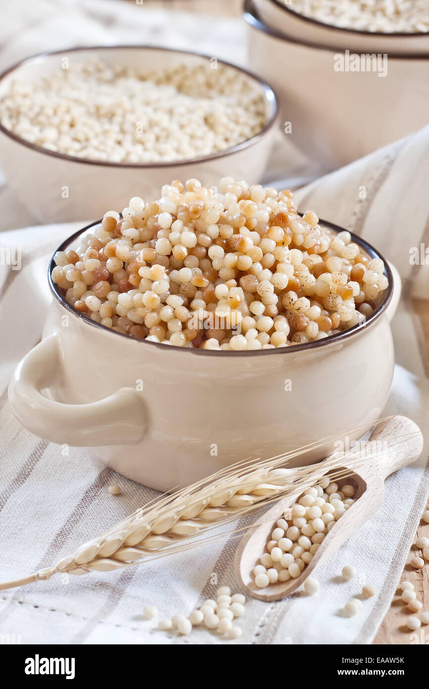 Ptititm or israel couscous - kind of small pasta, traditional for israel cuisine. Stock Photo