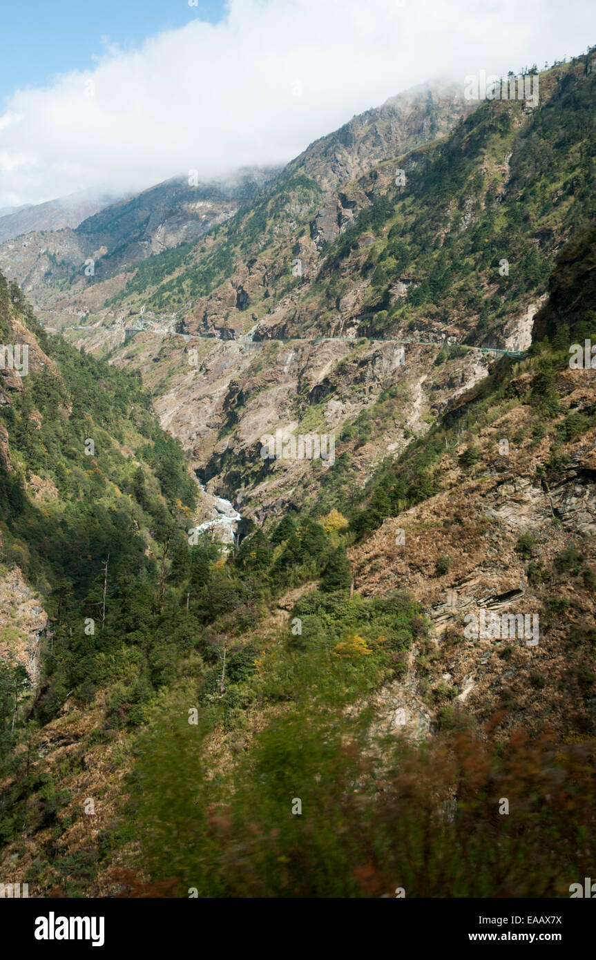 Friendship Highway drops into a steep gorge near the Nepalese border, Tibet, China Stock Photo