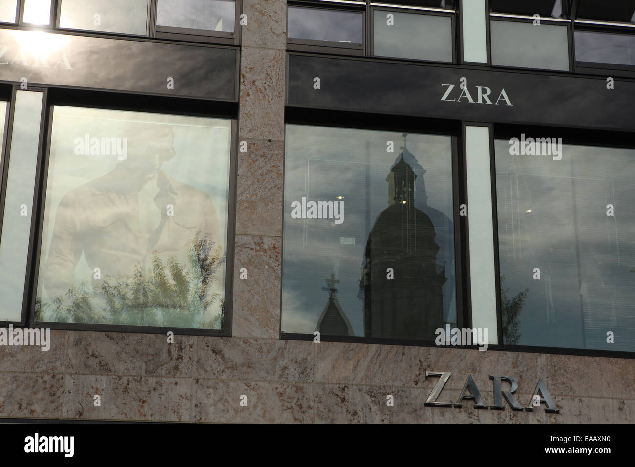 Reflection of St Thomas Church (Thomaskirche) in windows of Zara shop in Leipzig, Saxony, Germany. Stock Photo