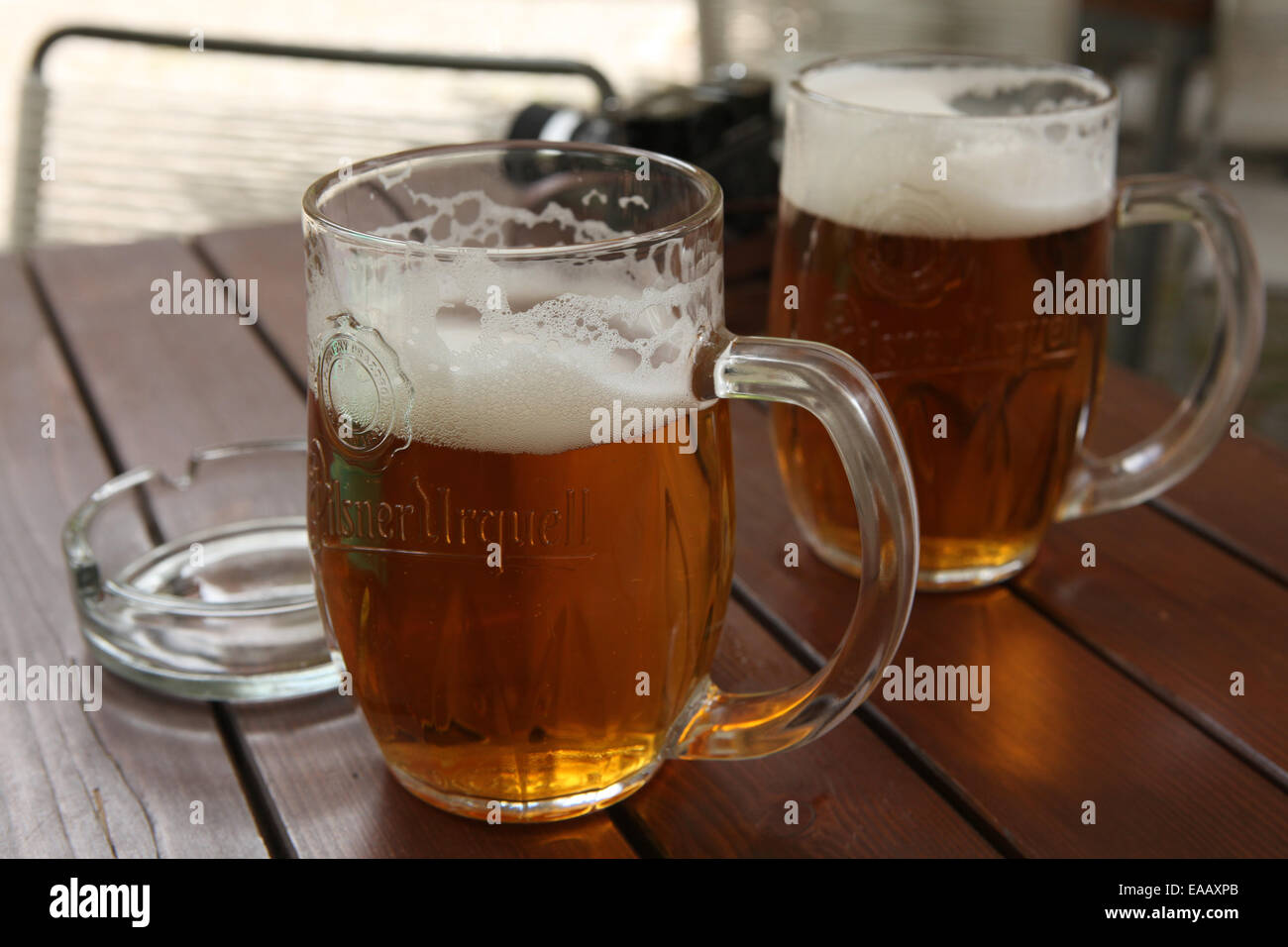 Two mugs of traditional Czech beer Pilsner Urquell seen in a pub in Prague, Czech Republic. Stock Photo