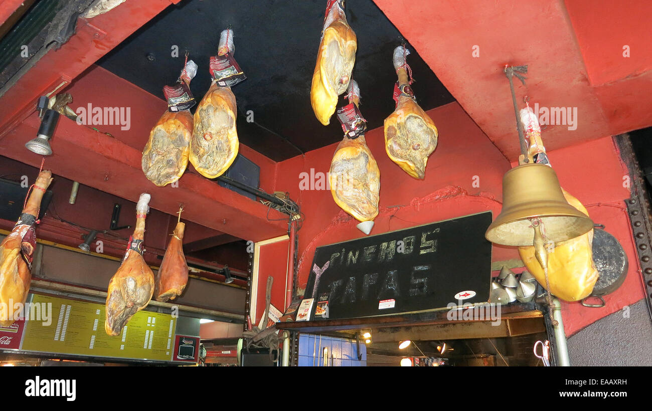 ham hanging from the ceiling of a restaurant port market ...