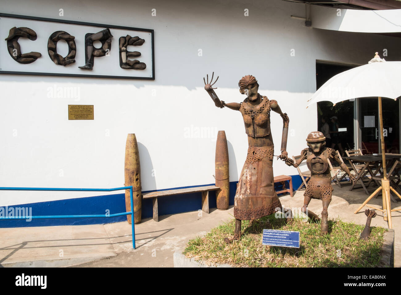 Statue made of unexploded ordnance (UXO) of a woman outside the COPE center which helps survivors of UXO.Vientiane,Laos,Asia. Stock Photo